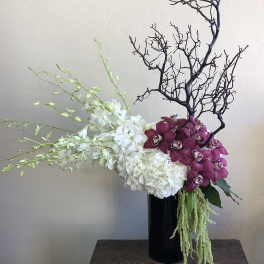 orchids and branch in vase