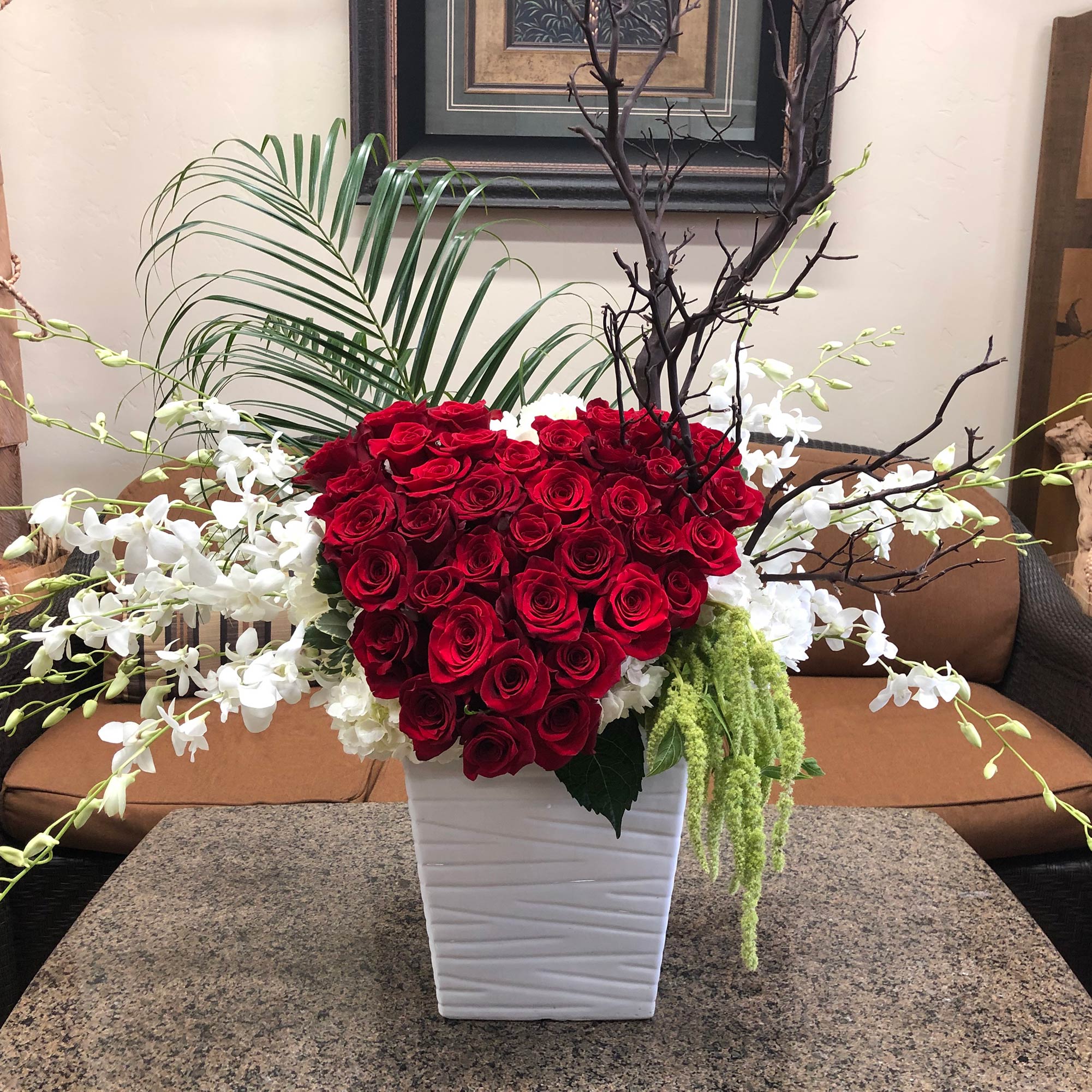 large red heart of roses with orchids