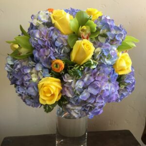 Ranunculus, roses and hydrangeas in a vase