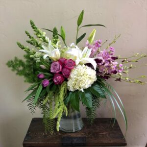 orchids, hydrangeas, roses in a large vase