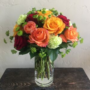 Roses of many colors in a vase