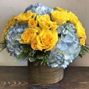 yellow and blue flowers in a vase