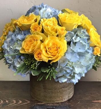yellow and blue flowers in a vase