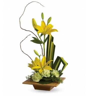 yellow asiatic lilies and green carnations accented with tropical greenery