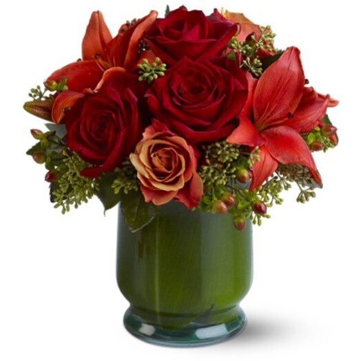 red roses and asiatic lilies in tea leaf lined vase