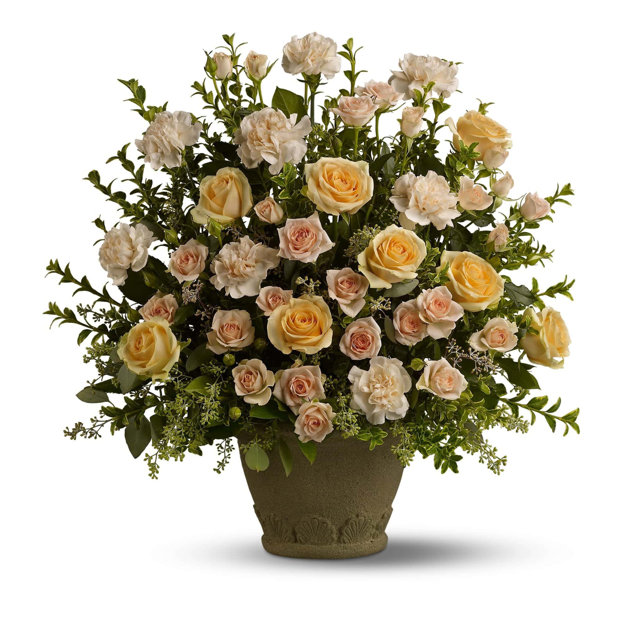 This stately arrangement features flowers such as peach roses and carnations accented with seeded eucalyptus