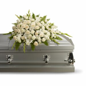 A gracious and tender tribute to a beautiful and cherished life, this elegant half casket spray radiates loveliness and serenity. Its soft and heavenly white flowers delicately speak your heartfelt emotions. Lovely flowers such as crème roses, white gladioli, stock and carnations, gracefully arranged with sword fern and other greens.