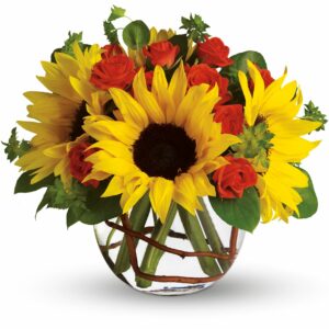 sunflowers and roses in a small glass vase